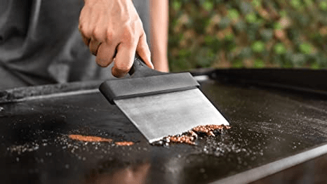 The scraper is the second most important tool for cleaning your flat top grill while cooking and especially afterward. It's perfect for removing excess grease and food from the surface. It's sturdy and does a better job than a spatula.