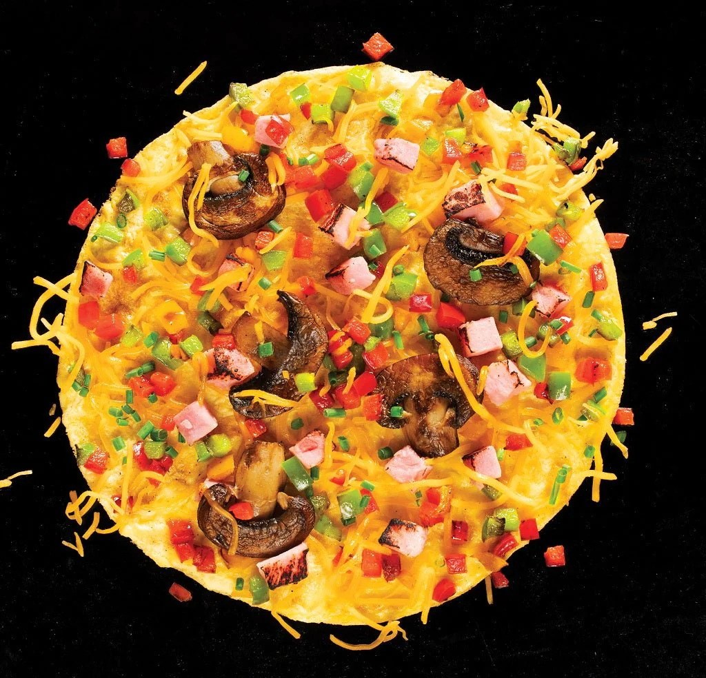 Once the edges are beginning to turn solid, it’s time to add the cheese and butter. Sprinkle your favorite cheese over the eggs, followed by any other toppings such as bacon, mushrooms, bell peppers and onions. After you have added all of your fillings, carefully fold one side of the omelet over the other using a spatula. Allow this side to cook for an additional minute before flipping onto its other side and cooking until both sides are golden brown. Serve with a sprinkle of fresh chives on top!